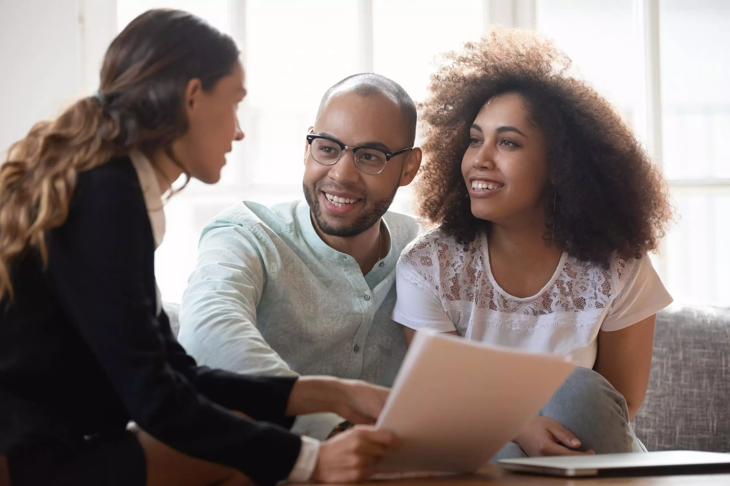 A young couple in a meeting with a lender or realtor